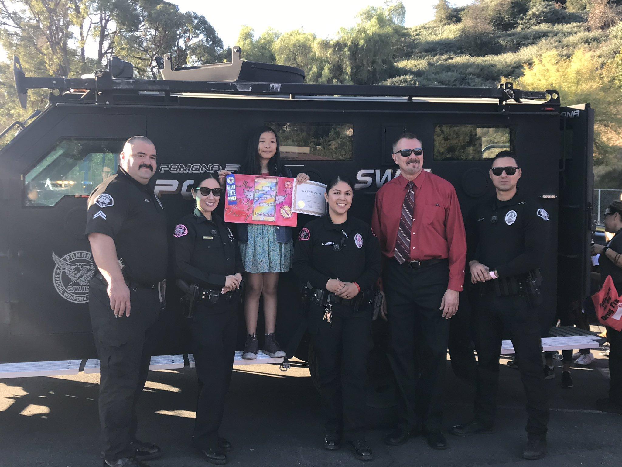 Joanna honored by the pomona police department, pictured is principal riffle and pomona police officers